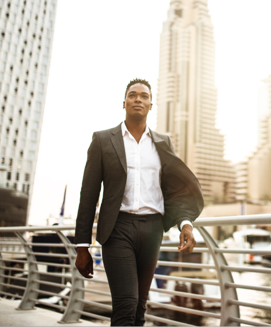 Black suited man walking bridge